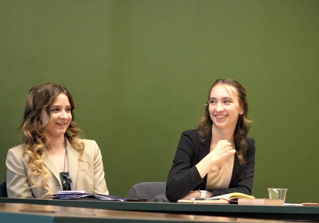 Two undergraduate women discussing a book